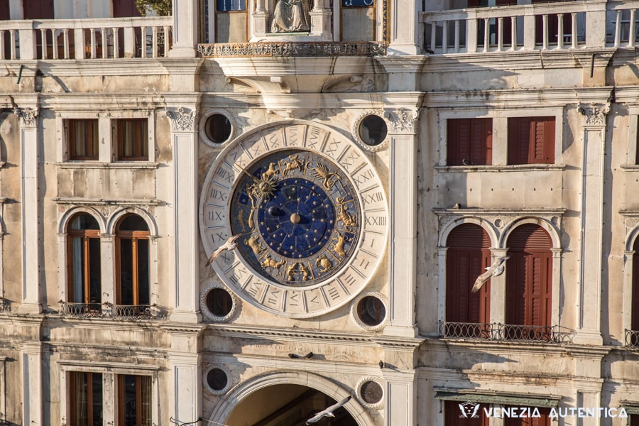 Particular of the Clock Tower in Saint Mark's Square in Venice. Golden Zodiac Signs on a blue background