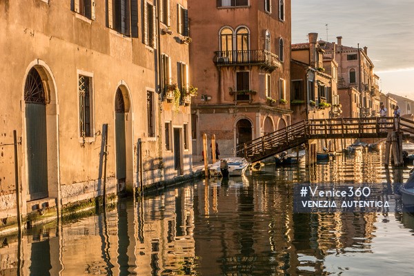 Golden light reflecting on a Venetian canal at sunset
