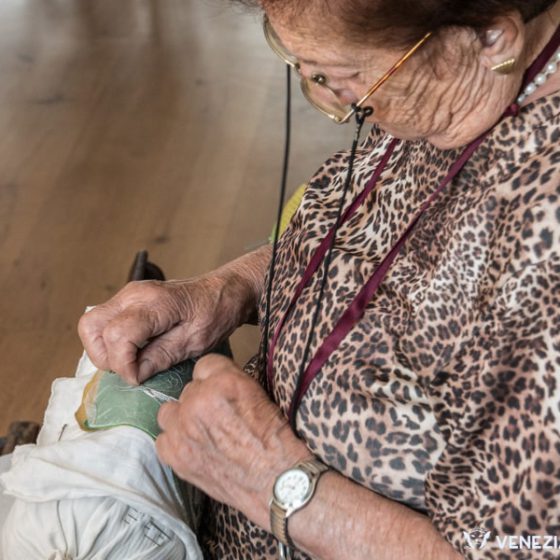 Expert hands working merletto at the Burano Lace Museum